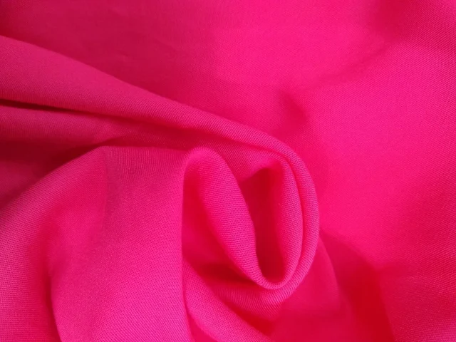 Pink rayon challis lying in soft folds.
