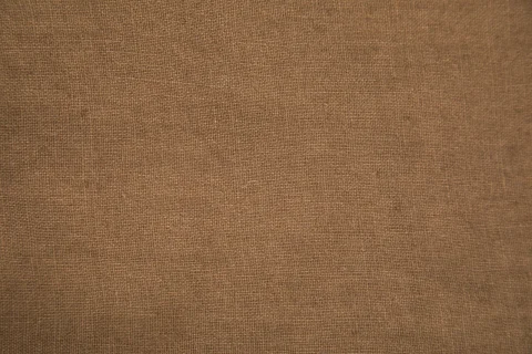 Close view of linen with an uneven slub texture.