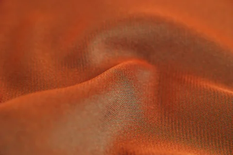 Folds of orange brushed twill.