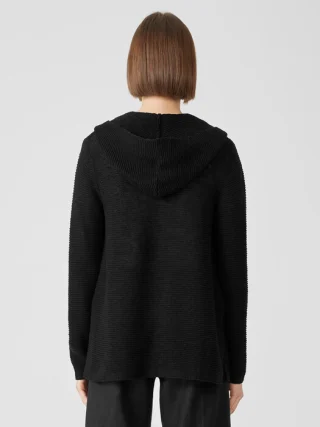 Back view of a black knitted cardigan with the hood lowered.
