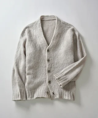A beige button-front cardigan laid flat.