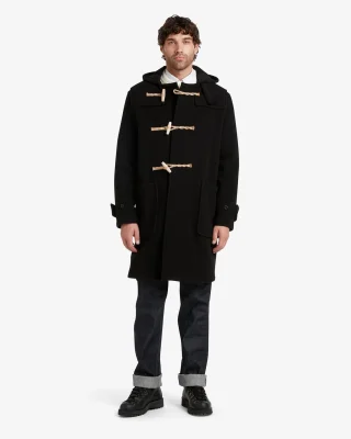 A black hooded duffle coat with pale rope loops, worn with cuffed dark jeans.