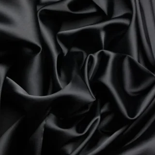 Black satin with bright highlights in its folds.