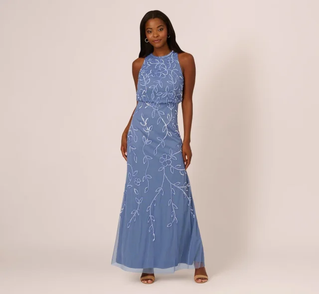 A pale blue beaded mermaid gown with a sleeveless bodice and a skirt that flares below the thighs.