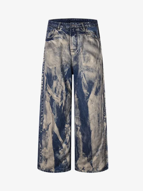 Wide jeans with pale, irregular marbling over dark denim.