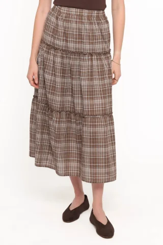 A brown checked tiered skirt with frilled seams and a wide lower tier.