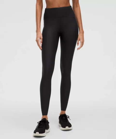 Black running tights with shaped seams across the waistband.