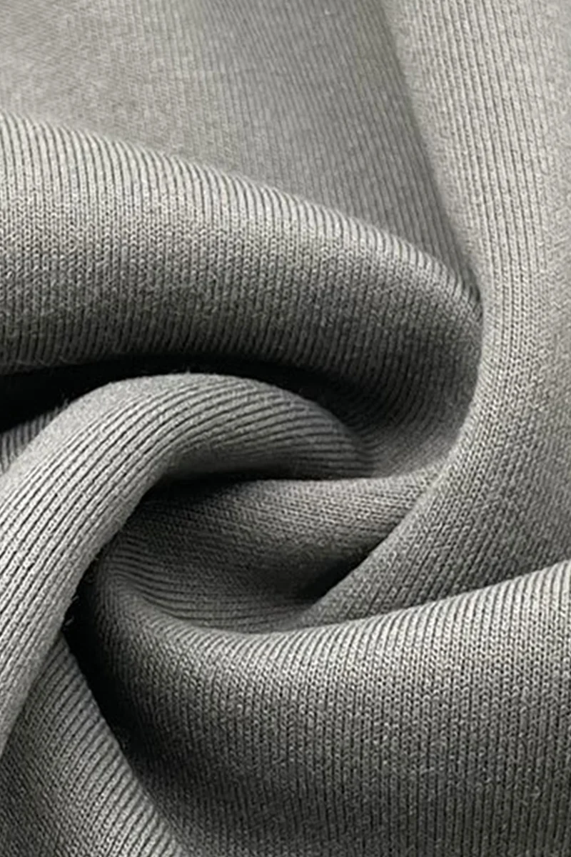 Gray sweatshirt fabric gathered in soft folds.