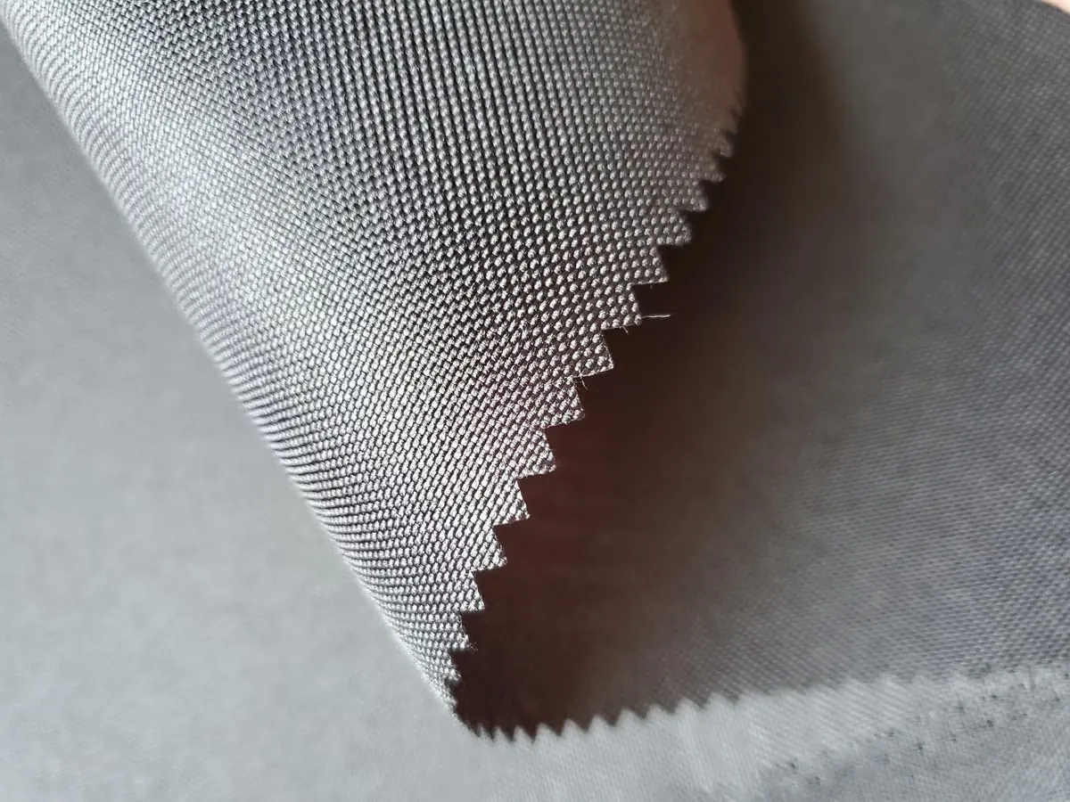 Gray performance knit with a zigzag-cut edge.