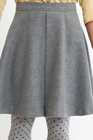 A gray circle skirt with a box pleat at the front.