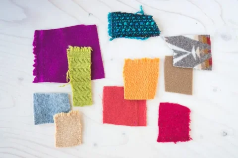 Swatches of wool coating in different colors, weaves and surface textures.