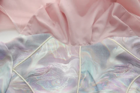 The neckline of a pale dress turned out to show where the pink lining meets the outer fabric.