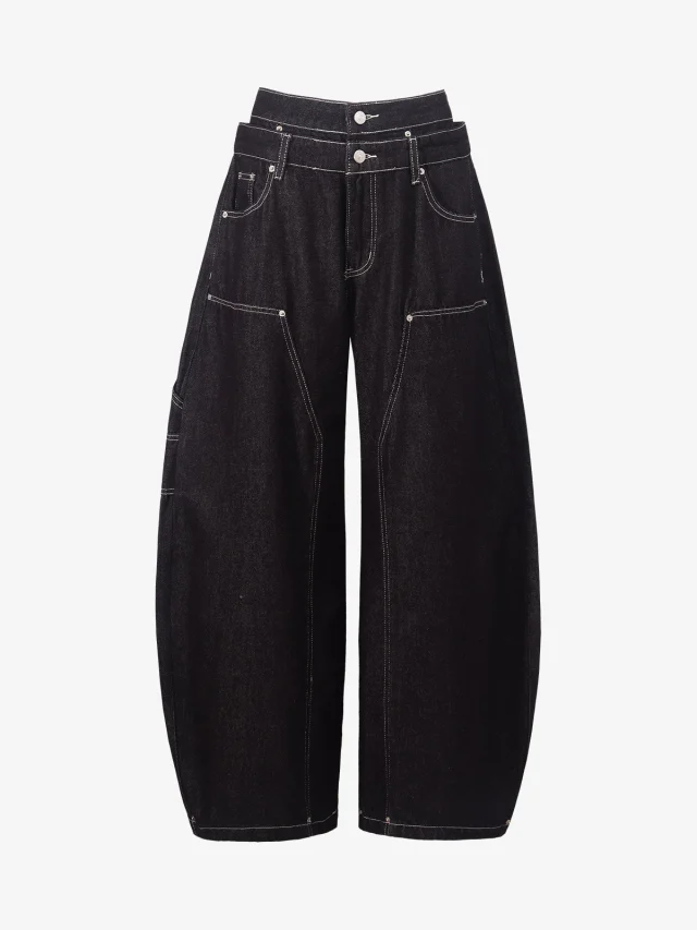 Black barrel-leg jeans with white topstitching and a double waistband.