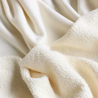 Cream French terry folded to show the small loops on its back.