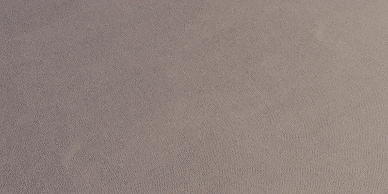 Fine stitch texture across a cotton jersey fabric surface.
