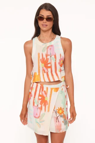 A floral wrap mini skirt with a curved overlapping front and a tie at the side.