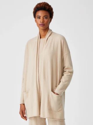 Long light beige open-front cardigan with deep patch pockets.