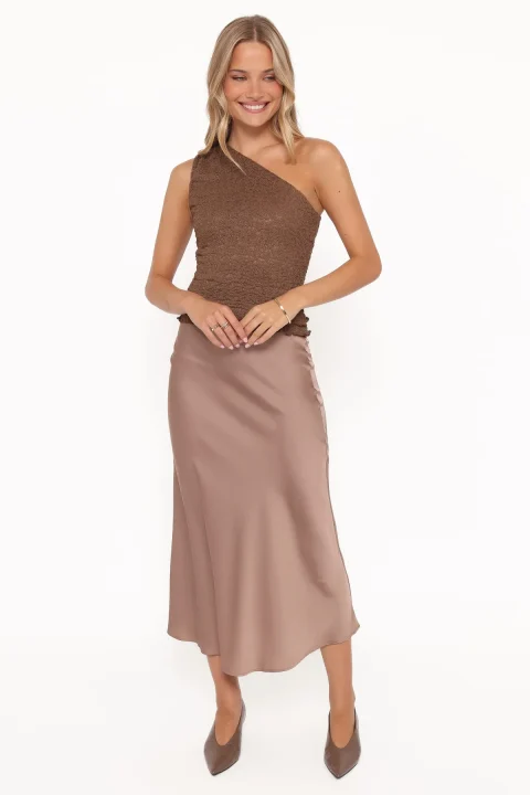Mocha satin slip skirt with a lightly flared hem, worn with a brown knit top and pointed-toe pumps.