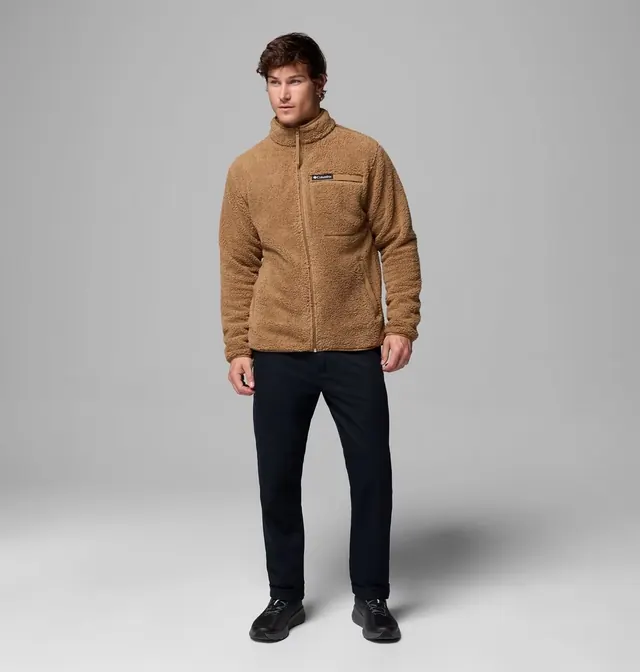 Model wearing a tan high-pile fleece, dark trousers and black shoes.