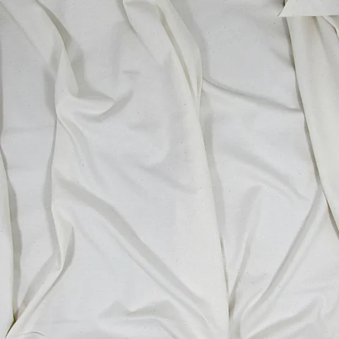 Natural white cotton jersey in soft folds, with its knitted surface visible.
