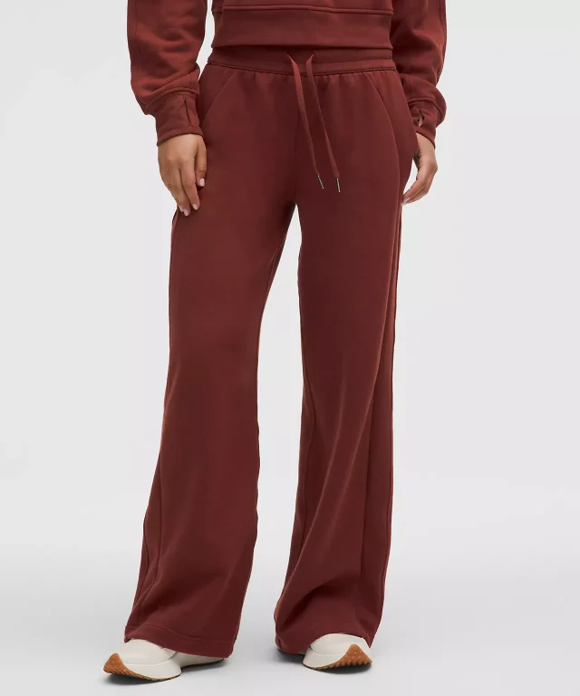 Brick-red sweatpants with a drawcord waist worn with a matching top.
