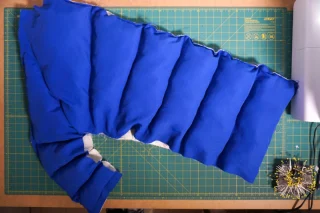 A blue coat panel with filled channels before the open edges are closed.