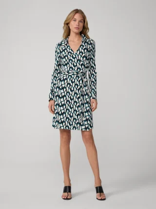 A printed jersey wrap dress with long sleeves, a collar and a tie at the waist.