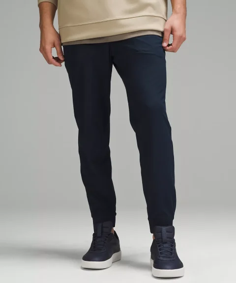 Navy tapered joggers with fitted ankle cuffs.