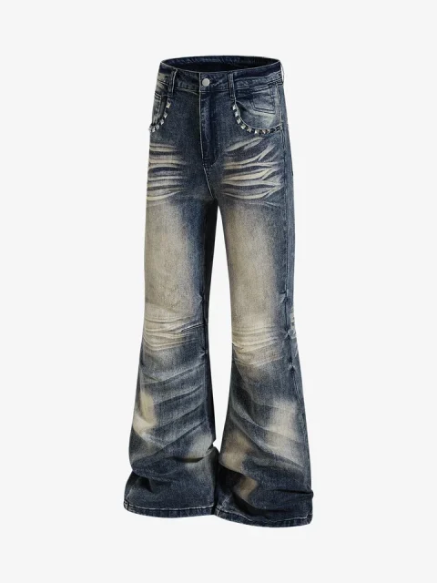 Flared jeans in a dark tinted wash with pale worn areas on the thighs and knees.