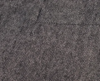 Close view of black and white herringbone suiting.