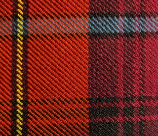 Close view of red and black tartan twill.
