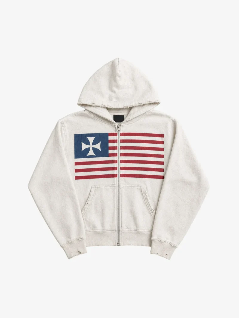 Product photo of a vintage-look off-white zip hoodie. Its zip runs straight through a flag print on the chest.