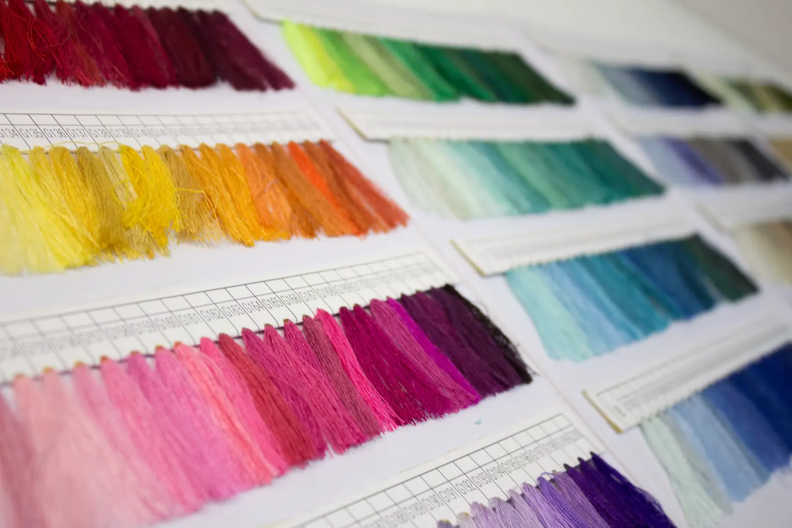 A thread shade card with rows of colored thread samples.
