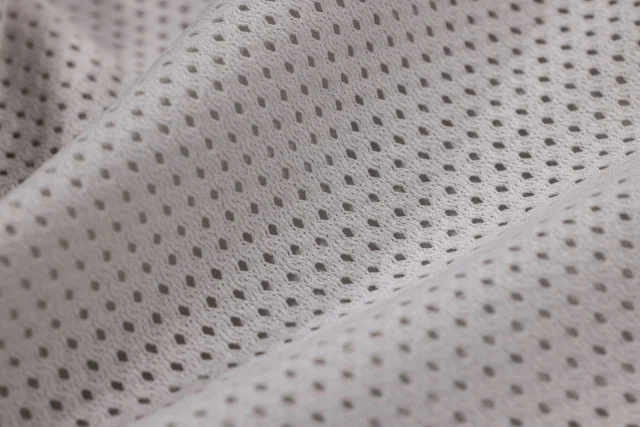 Light gray polyester mesh with small, evenly spaced holes.