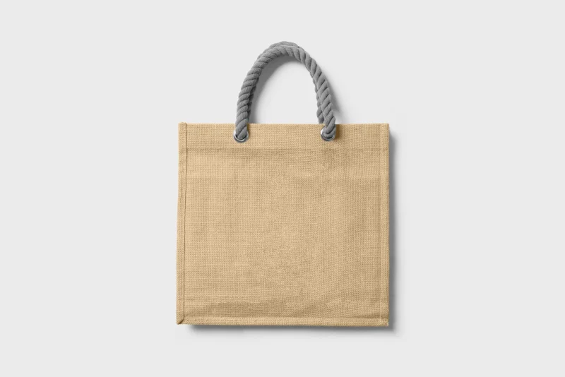 A jute tote with gray rope handles on a light gray background.