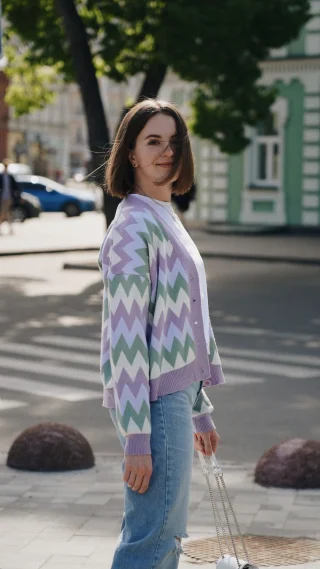 Pastel zigzag cardigan worn with light jeans on a city street.
