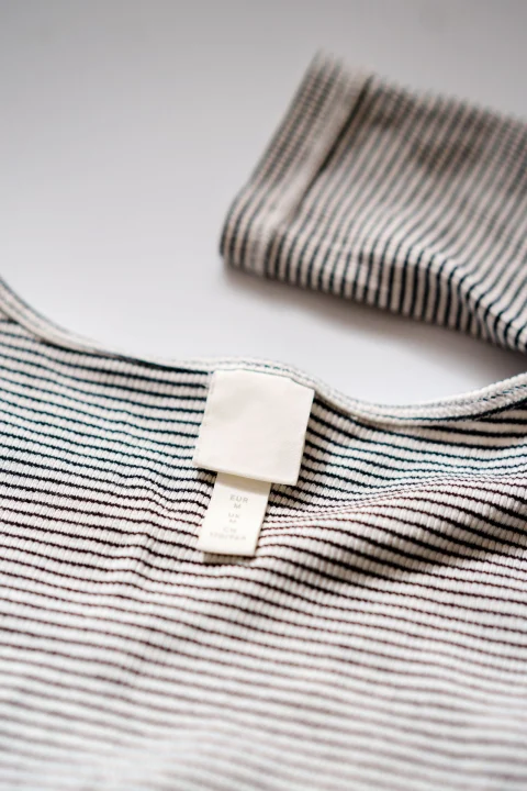 A blank label sewn into a striped knit top.